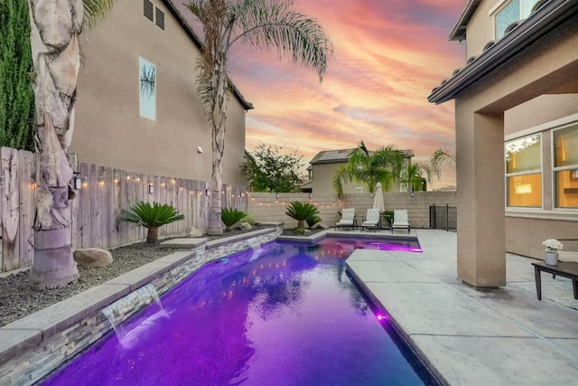 11617 N Bella Verde Ave, Fresno, CA 93730 - pool at dusk with a patio area and a fenced backyard
