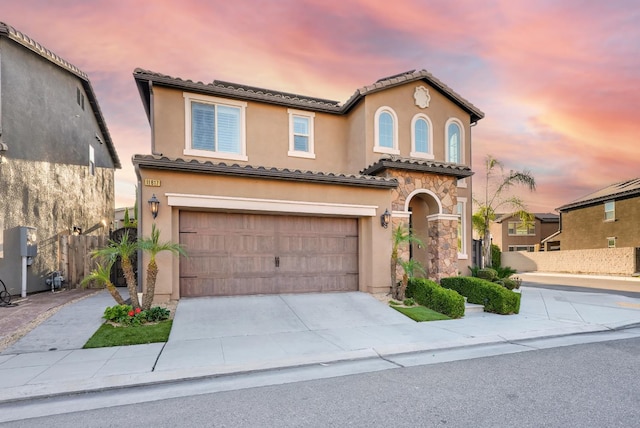 11617 N Bella Verde Ave, Fresno, CA 93730 - mediterranean / spanish house with driveway, a garage, stucco siding, and a tiled roof