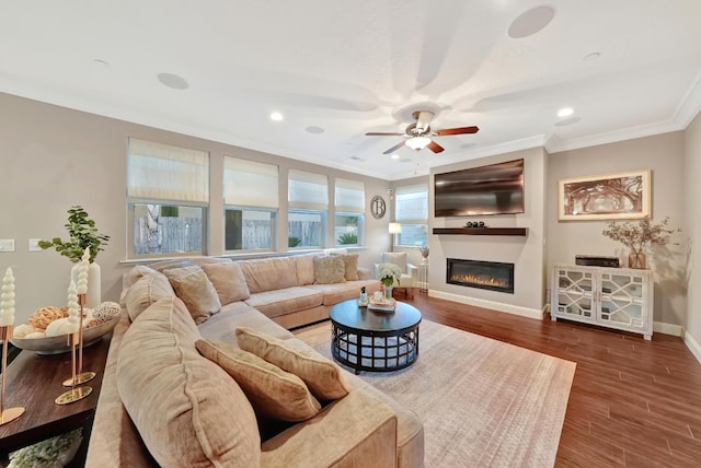 11617 N Bella Verde Ave, Fresno, CA 93730 - living area with ceiling fan, crown molding, wood finished floors, a glass covered fireplace, and recessed lighting