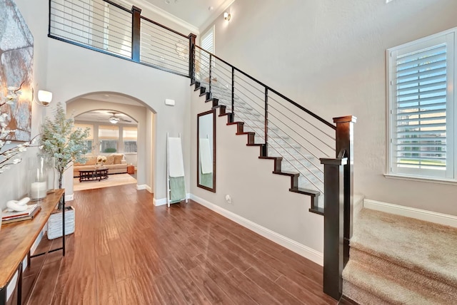 11617 N Bella Verde Ave, Fresno, CA 93730 - foyer entrance featuring stairway, arched walkways, wood finished floors, and a high ceiling
