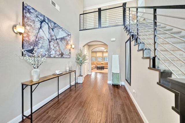 11617 N Bella Verde Ave, Fresno, CA 93730 - foyer with arched walkways, wood finished floors, and stairway