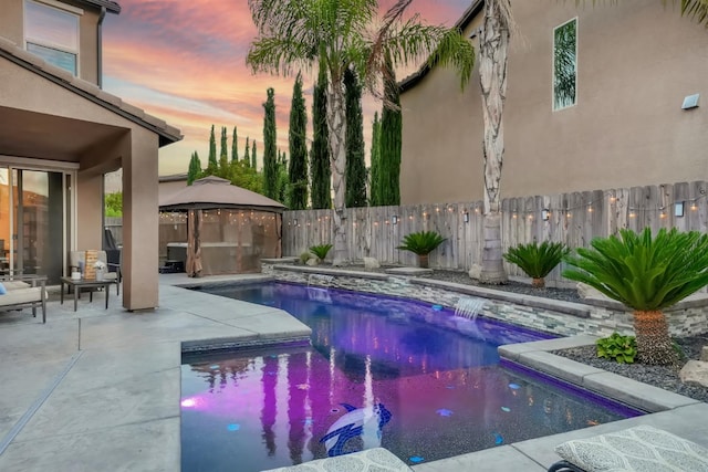 11617 N Bella Verde Ave, Fresno, CA 93730 - pool at dusk featuring a gazebo, a fenced backyard, and a patio
