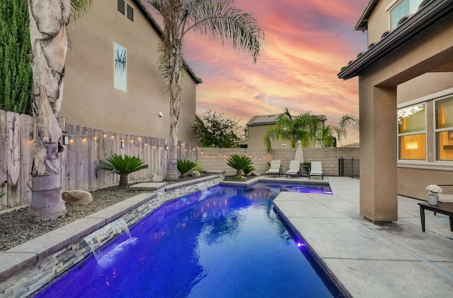 11617 N Bella Verde Ave, Fresno, CA 93730 - pool at dusk featuring a fenced backyard and a patio area