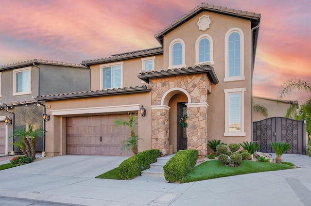 11617 N Bella Verde Ave, Fresno, CA 93730 - mediterranean / spanish-style house featuring stone siding, concrete driveway, stucco siding, a garage, and a tile roof