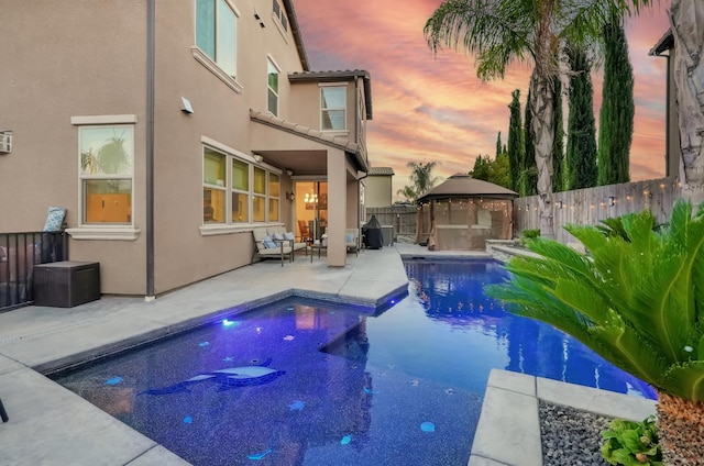 11617 N Bella Verde Ave, Fresno, CA 93730 - pool at dusk with a gazebo, a fenced backyard, and a patio area