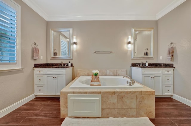 11617 N Bella Verde Ave, Fresno, CA 93730 - bathroom featuring two vanities, a garden tub, crown molding, and wood finish floors
