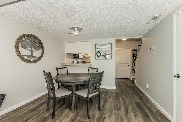 4885 N Backer Ave Unit 113, Fresno, CA 93726 - dining area featuring dark wood-style floors and a textured ceiling