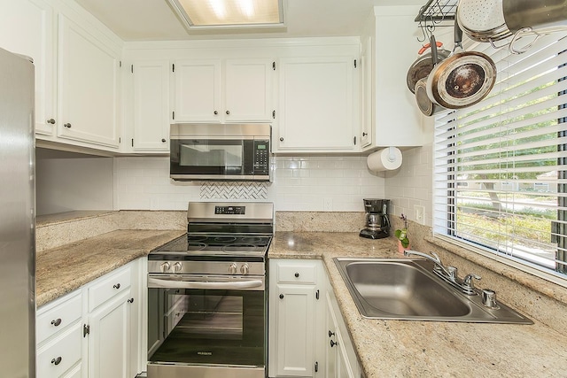 4885 N Backer Ave Unit 113, Fresno, CA 93726 - kitchen featuring stainless steel appliances, white cabinetry, and tasteful backsplash