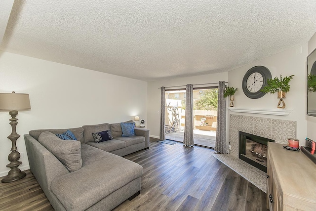 4885 N Backer Ave Unit 113, Fresno, CA 93726 - living area with dark wood finished floors, a textured ceiling, and a fireplace