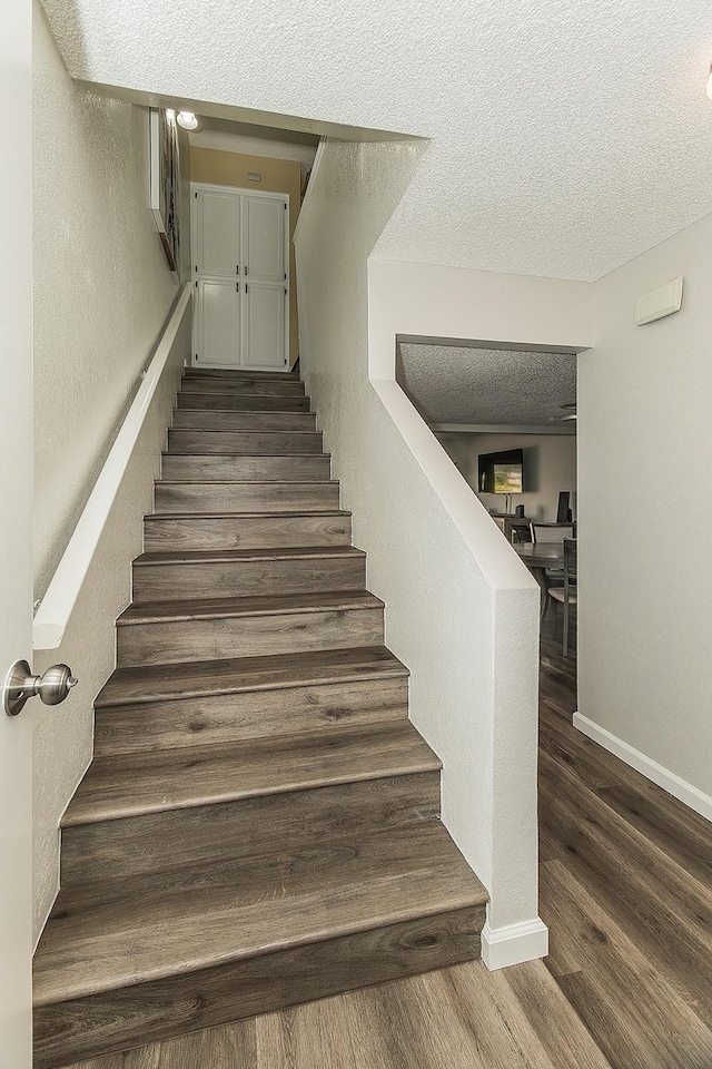 4885 N Backer Ave Unit 113, Fresno, CA 93726 - stairway featuring a textured ceiling and wood finished floors