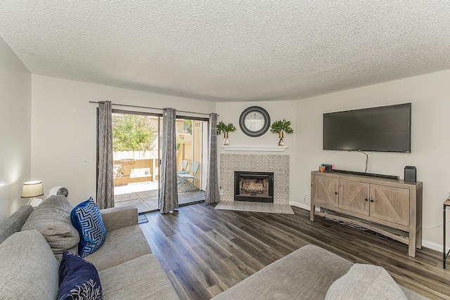 4885 N Backer Ave Unit 113, Fresno, CA 93726 - living room with dark wood-type flooring, a fireplace, and a textured ceiling