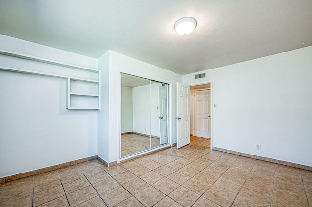 545 W Fedora Ave, Fresno, CA 93705 - unfurnished bedroom featuring light tile patterned floors and a closet