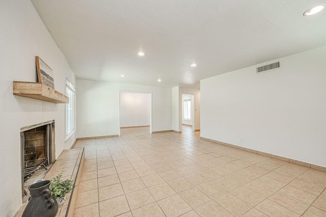 545 W Fedora Ave, Fresno, CA 93705 - unfurnished living room featuring recessed lighting, a fireplace with raised hearth, and light tile patterned floors