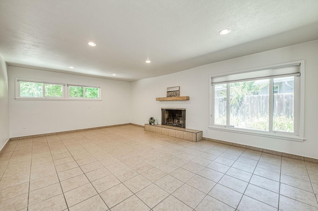 545 W Fedora Ave, Fresno, CA 93705 - unfurnished living room featuring a tile fireplace, recessed lighting, and light tile patterned floors