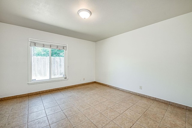 545 W Fedora Ave, Fresno, CA 93705 - spare room with baseboards and light tile patterned floors