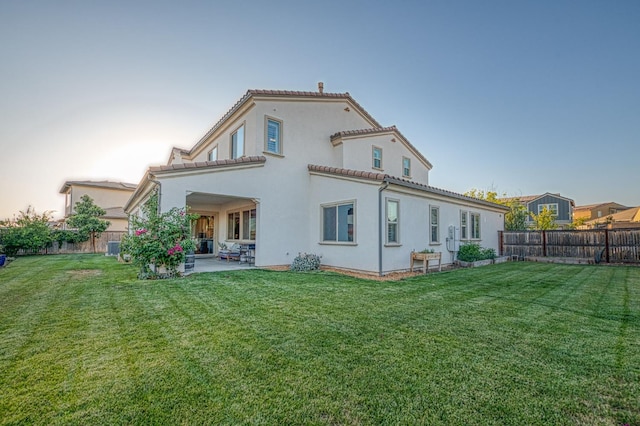 924 Orchard Hills Rd, Madera, CA 93636 - back of house featuring a patio area, a fenced backyard, stucco siding, and a tile roof