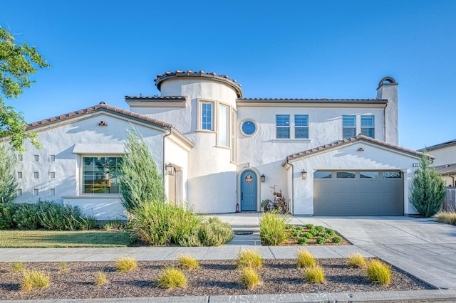 924 Orchard Hills Rd, Madera, CA 93636 - mediterranean / spanish-style house with concrete driveway, stucco siding, a tiled roof, a chimney, and a garage