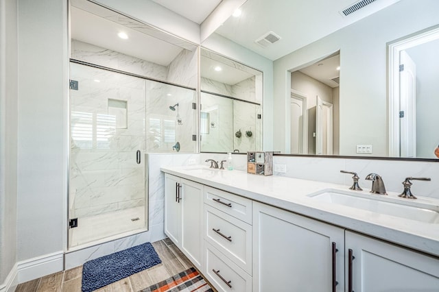 924 Orchard Hills Rd, Madera, CA 93636 - full bath with double vanity, a marble finish shower, wood finished floors, and recessed lighting