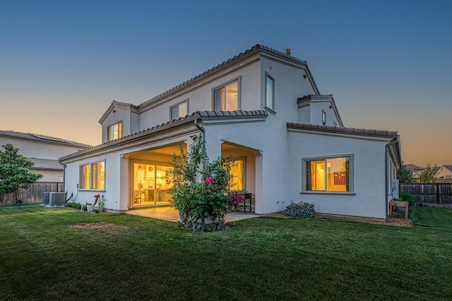 924 Orchard Hills Rd, Madera, CA 93636 - back of property at dusk with a patio area, stucco siding, and a tile roof