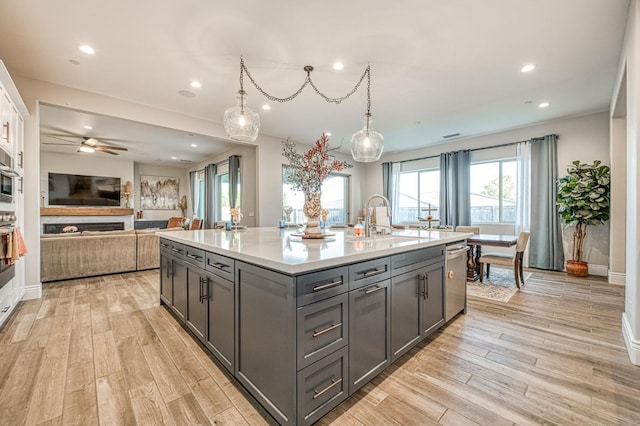 924 Orchard Hills Rd, Madera, CA 93636 - kitchen featuring gray cabinets, light wood-type flooring, dishwasher, light countertops, and open floor plan