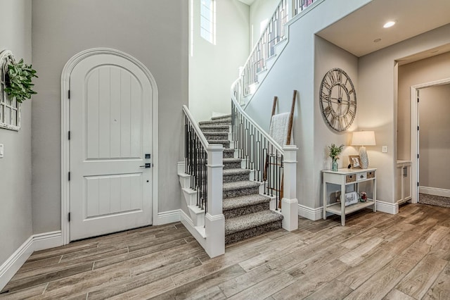 924 Orchard Hills Rd, Madera, CA 93636 - foyer entrance featuring wood finished floors, stairs, a high ceiling, and recessed lighting