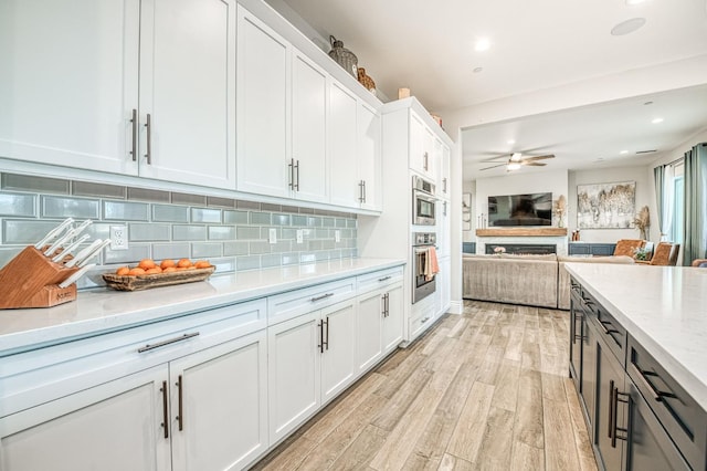 924 Orchard Hills Rd, Madera, CA 93636 - kitchen with white cabinets, light wood finished floors, ceiling fan, tasteful backsplash, and recessed lighting