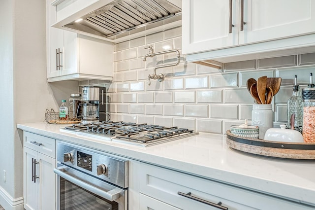 924 Orchard Hills Rd, Madera, CA 93636 - kitchen featuring stainless steel appliances, premium range hood, backsplash, white cabinetry, and light stone counters