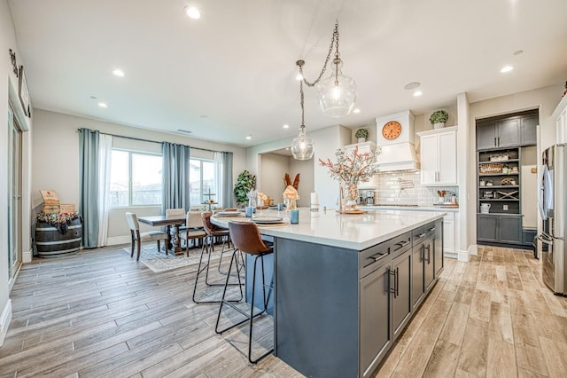 924 Orchard Hills Rd, Madera, CA 93636 - kitchen featuring gray cabinetry, light wood-type flooring, stainless steel fridge, light countertops, and recessed lighting