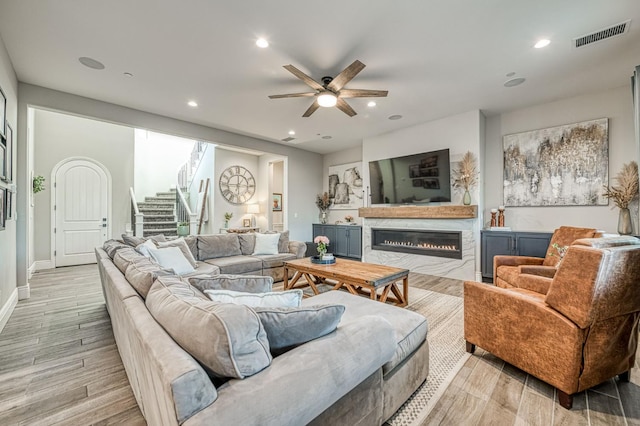 924 Orchard Hills Rd, Madera, CA 93636 - living area with a glass covered fireplace, light wood-type flooring, a ceiling fan, stairs, and recessed lighting