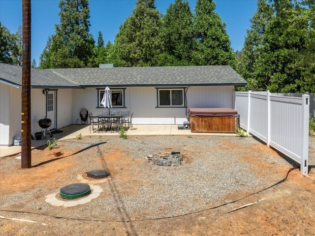 53401 Timberview Rd, North Fork, CA 93643 - view of front of house featuring a hot tub, a patio, a shingled roof, and an outdoor fire pit