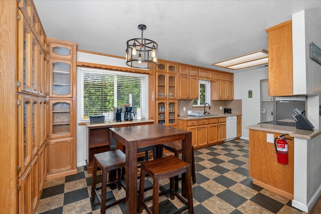 53401 Timberview Rd, North Fork, CA 93643 - kitchen with white dishwasher, dark flooring, light countertops, backsplash, and glass insert cabinets