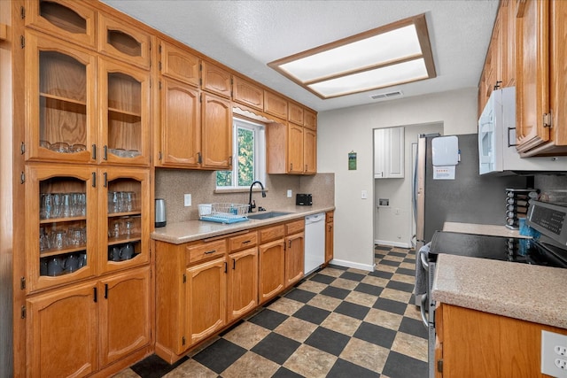 53401 Timberview Rd, North Fork, CA 93643 - kitchen featuring white appliances, dark flooring, light countertops, tasteful backsplash, and brown cabinets