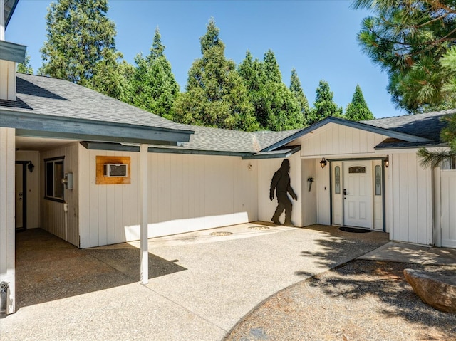 53401 Timberview Rd, North Fork, CA 93643 - entrance to property featuring a shingled roof and an AC wall unit