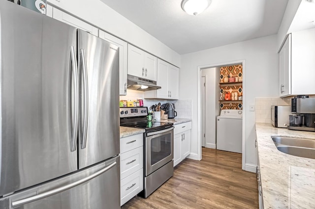 4679 E Pitt Ave, Fresno, CA 93725 - kitchen featuring stainless steel appliances, washer / dryer, under cabinet range hood, and decorative backsplash