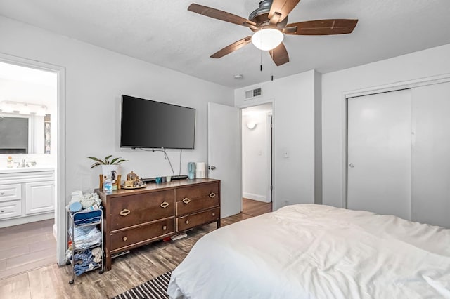 4679 E Pitt Ave, Fresno, CA 93725 - bedroom with a closet, wood finished floors, ensuite bath, and a ceiling fan