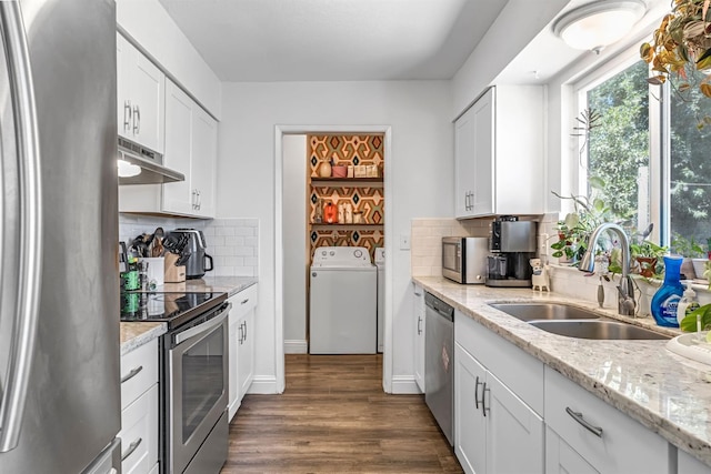 4679 E Pitt Ave, Fresno, CA 93725 - kitchen featuring appliances with stainless steel finishes, independent washer and dryer, under cabinet range hood, white cabinets, and dark wood-style floors