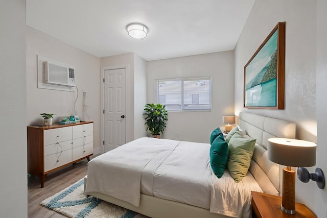 221 N Orchard St, Fresno, CA 93701 - bedroom with a wall mounted air conditioner and wood finished floors