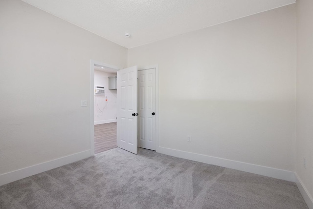 221 N Orchard St, Fresno, CA 93701 - spare room featuring light carpet, a wall mounted AC, and a smoke detector