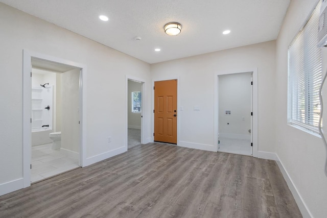 221 N Orchard St, Fresno, CA 93701 - unfurnished bedroom with wood finished floors, connected bathroom, and recessed lighting