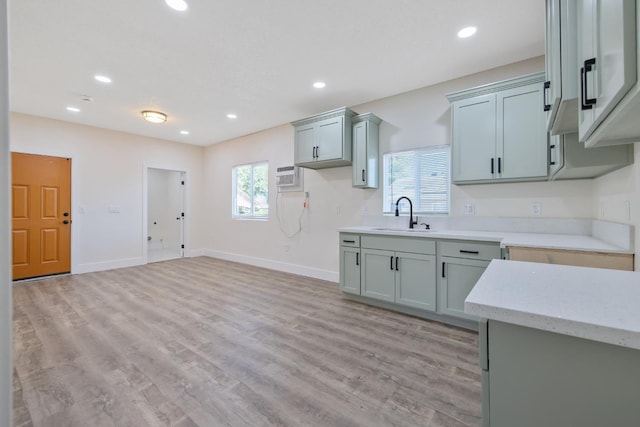 221 N Orchard St, Fresno, CA 93701 - kitchen featuring recessed lighting, light wood finished floors, a wall mounted air conditioner, and light stone countertops