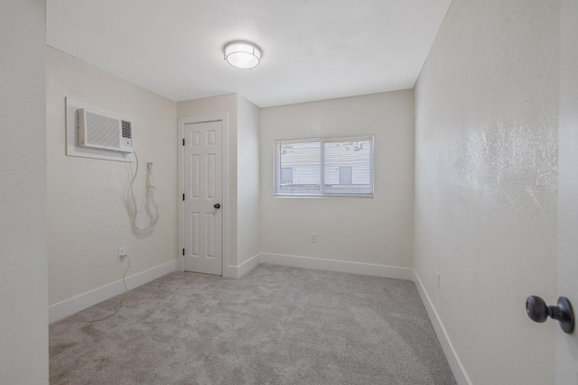 221 N Orchard St, Fresno, CA 93701 - unfurnished room featuring an AC wall unit and carpet flooring
