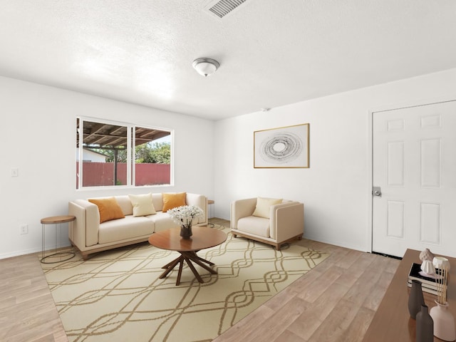 2557 Jackson St, Selma, CA 93662 - living room with light wood finished floors and a textured ceiling