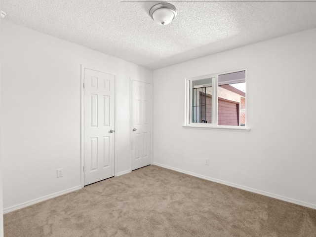 2557 Jackson St, Selma, CA 93662 - unfurnished bedroom with carpet flooring and a textured ceiling