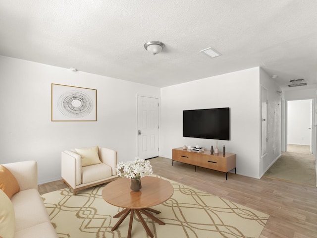 2557 Jackson St, Selma, CA 93662 - living room featuring light wood-type flooring and a textured ceiling