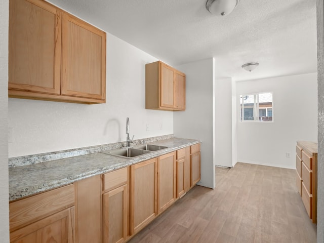 2557 Jackson St, Selma, CA 93662 - kitchen with light wood-style flooring, light countertops, light brown cabinetry, and a textured ceiling