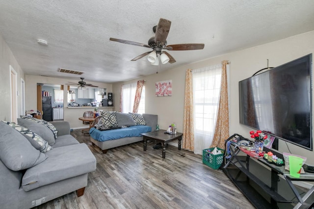 448 E Tuolumne St, Fresno, CA 93706 - living room with a ceiling fan, a textured ceiling, and wood finished floors