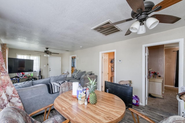 448 E Tuolumne St, Fresno, CA 93706 - dining space with ceiling fan, a textured ceiling, and wood finished floors