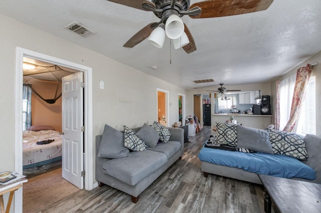 448 E Tuolumne St, Fresno, CA 93706 - living room with wood finished floors, ceiling fan, and a textured ceiling