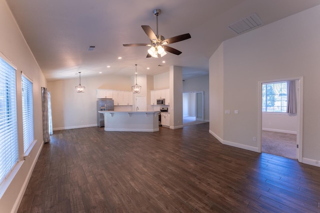 1963 Rialto Ct, Clovis, CA 93611 - unfurnished living room featuring vaulted ceiling, dark wood-style floors, a ceiling fan, and recessed lighting