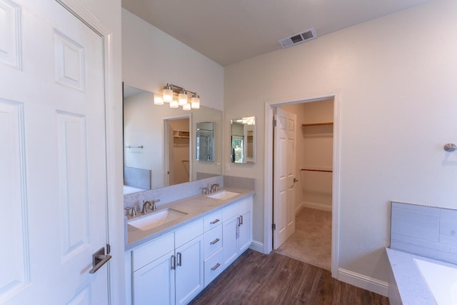 1963 Rialto Ct, Clovis, CA 93611 - full bath with wood finished floors, double vanity, a spacious closet, and a bathtub